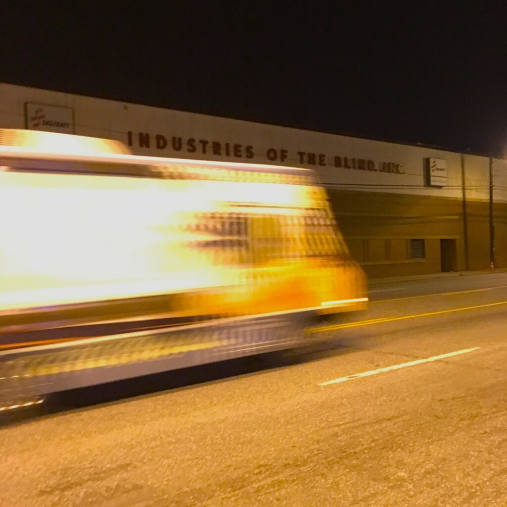 Photo of a bus blurred and passing by Charles Corriher in Backchannels Journal literary magazine